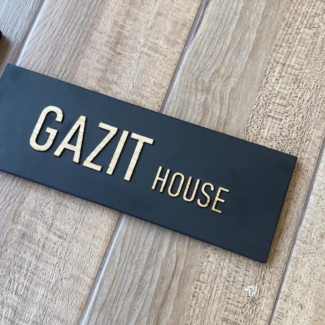 A custom-designed black concrete house entrance sign with wooden lettering - HOUSE series